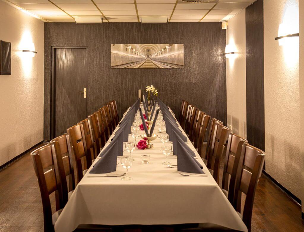 Festlich gedeckter langer Tisch in stilvoller Eventlocation mit Holzboden und Stoffservietten Gilde Bowling Wandsbek
